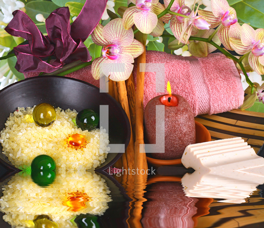 Spa accessories with orchid flowers on black background