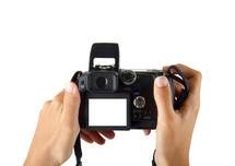 hands taking picture with a compact digital camera