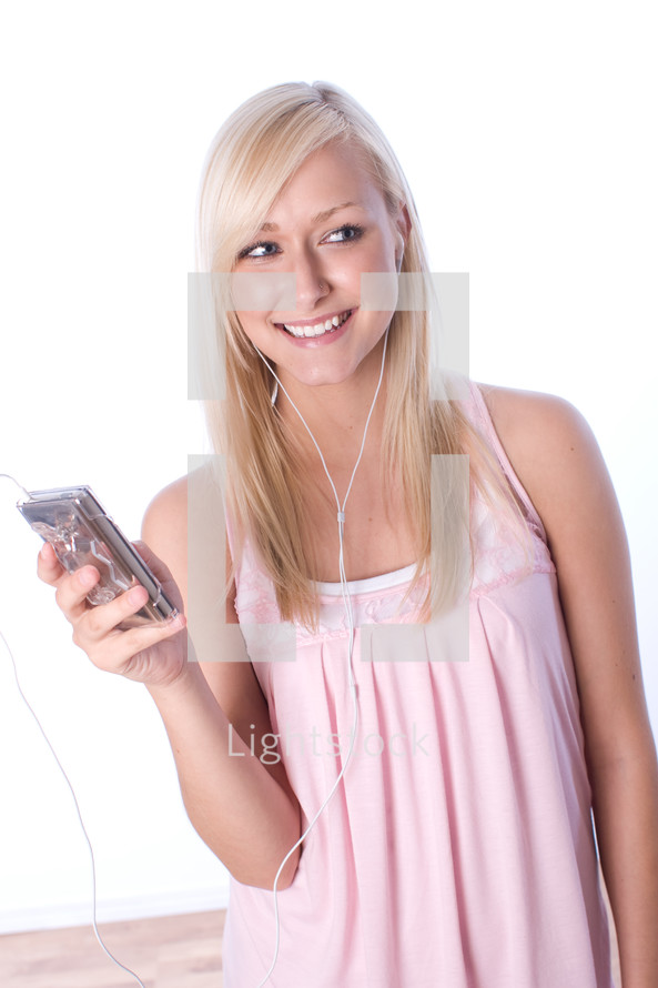 young woman listening to music with earbuds