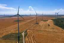 Eolian field and wind turbines farm on countryside in a sunny day