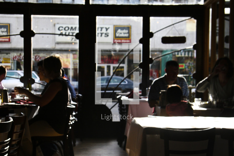 silhouettes of people at a coffee shop