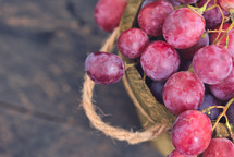 red grapes in a wooden basket 