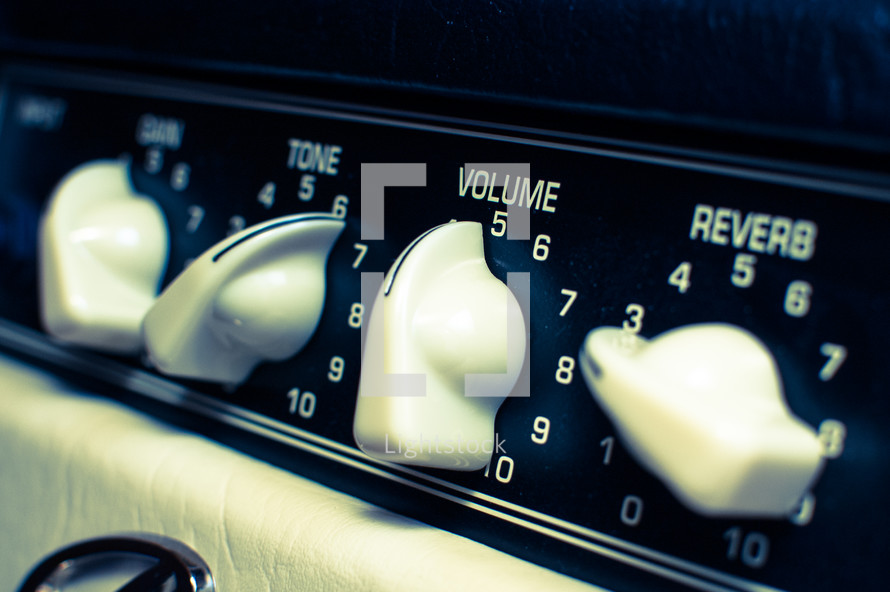  photo of guitar amplifier level dials: gain, tone, volume & reverb in cross-processed look.
