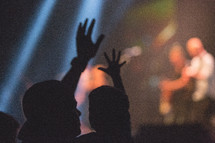 silhouettes of a father and son at a concert 