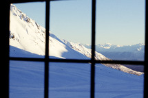 view of a snowy peak out of a window 