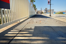 Sidewalk with fence shadows