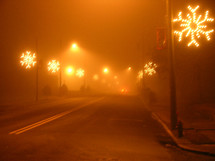 Christmas lights at night in the fog 