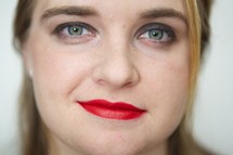 face of a woman wearing red lipstick