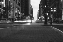 brick sidewalk in a city at night 