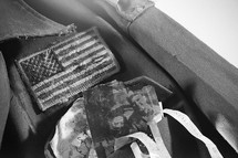 American flag patch and family photos on a soldier's uniform.