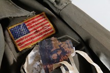 American flag and family photos on a soldier's uniform.