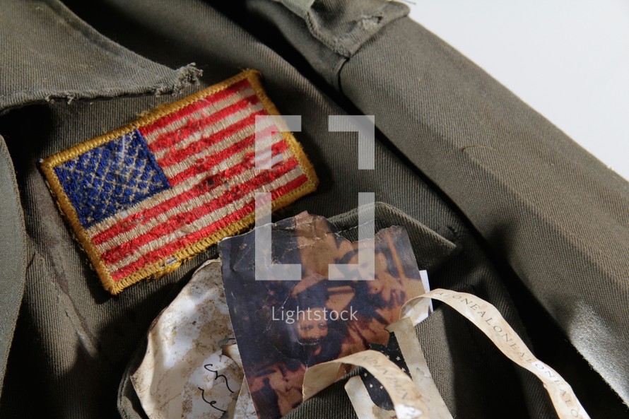 American flag and family photos on a soldier's uniform.
