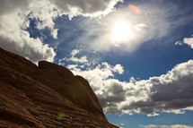 blue sky and white clouds over a red rock formation in Nevada