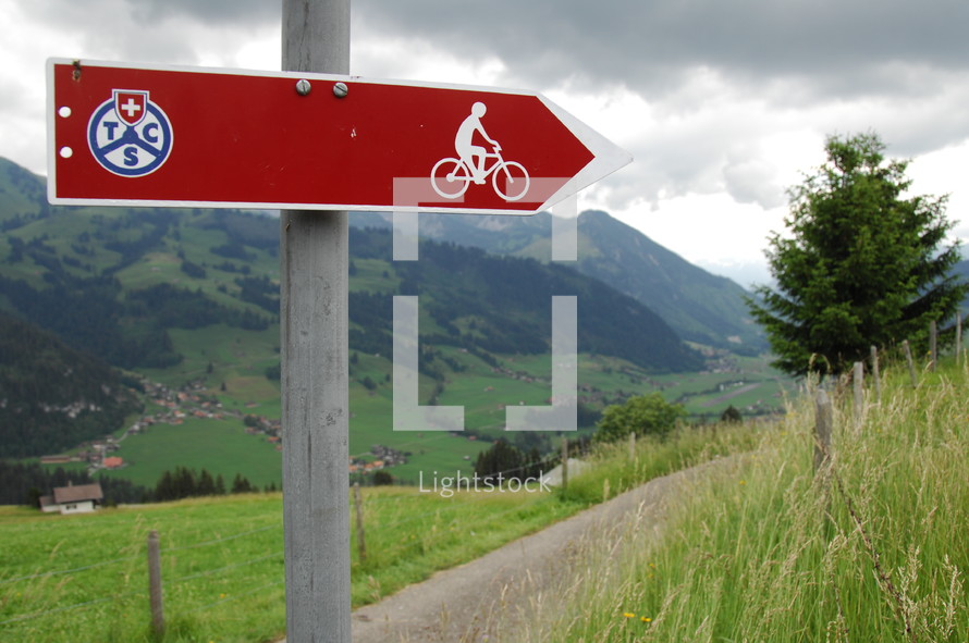 sign pointing the way to a bike trail 