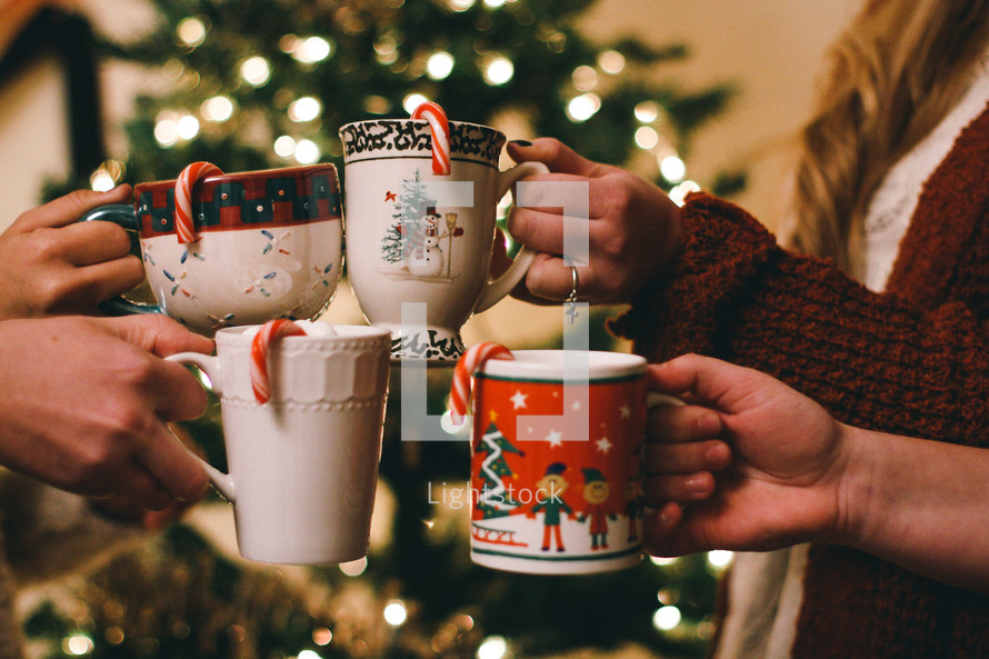 toasting with mugs of hot cocoa 