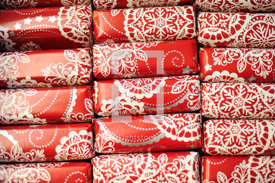 stacked wrapped red and white gift boxes 