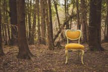 yellow chair in a forest 
