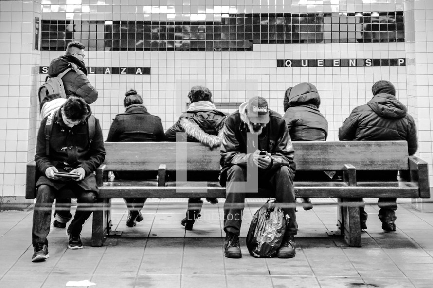people waiting in a subway station 