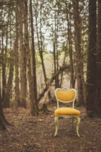 yellow chair in a forest 