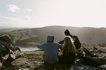 friends sitting on a mountaintop in New Zealand 