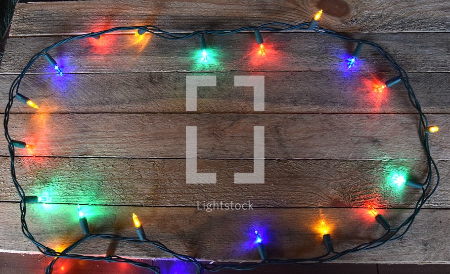 Border of Christmas Lights on wooden background