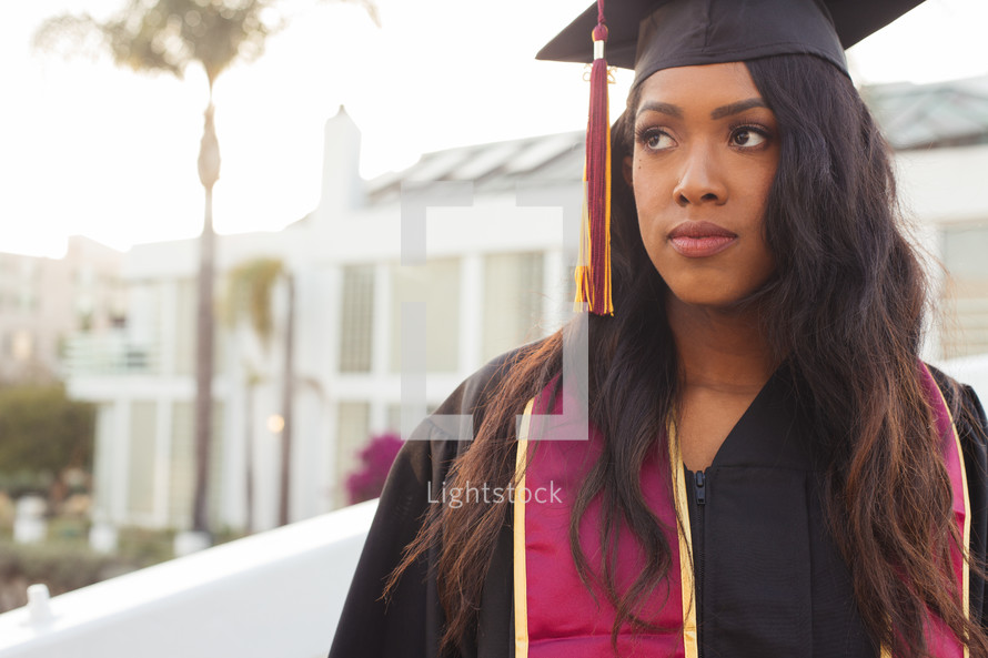 female African American graduate in cap and gown 