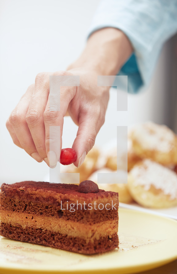 putting a cherry on a cake 