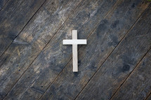 cross on a rustic wood background 