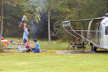 A young family enjoys time together while camping.