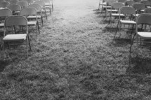 rows of folding chairs in grass 