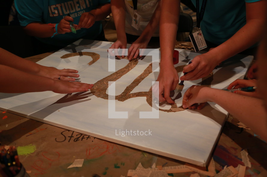 Teens making a poster. 