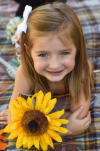toddler girl with a sunflower 
