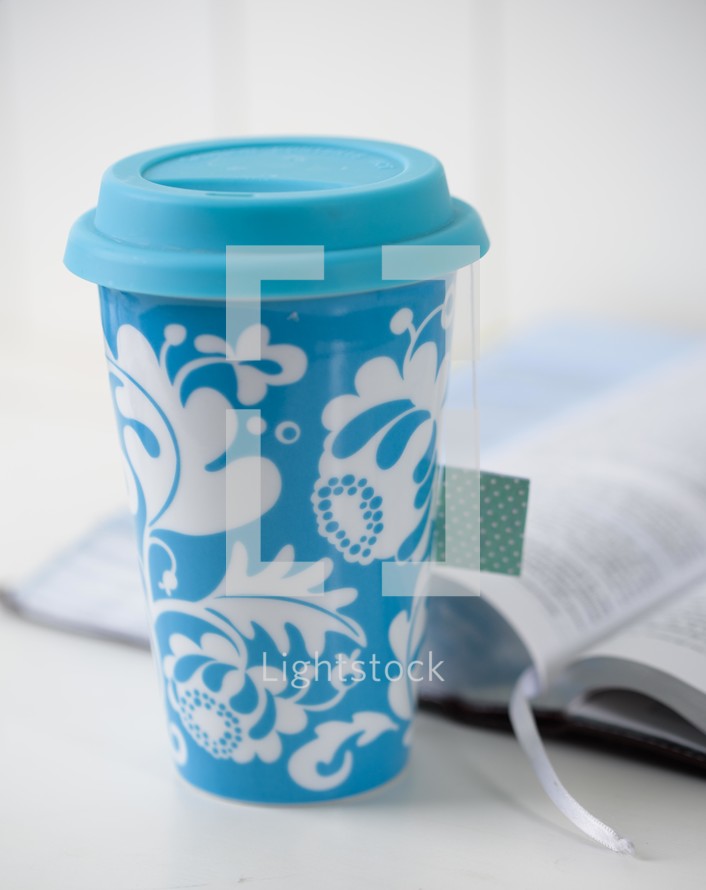 blue cup and open Bible 