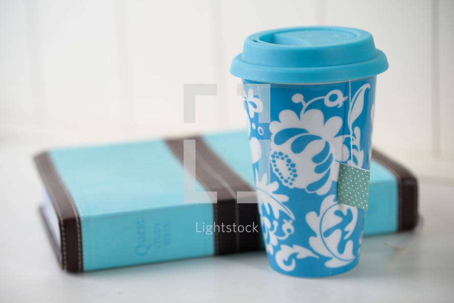 blue coffee cup and Bible 