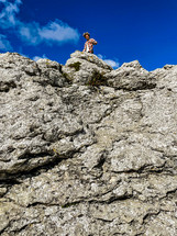 a man standing on a rocky cliff 