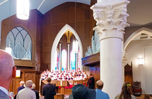 Church choir in robes singing in service