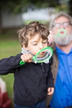 grandfather and grandsons blowing bubbles 