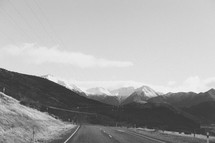 A highway leading toward a mountain range.