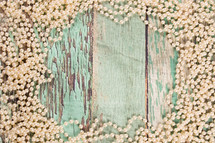 pearls on green wood background 