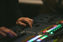 man behind a soundboard 