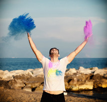 young man at sunset with colored powder.