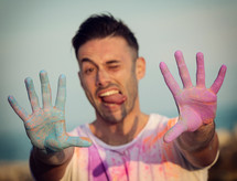 young man at sunset with colored powder.