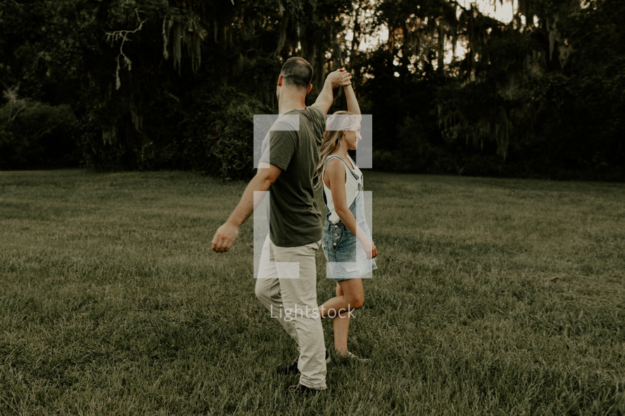 a couple dancing in a field 