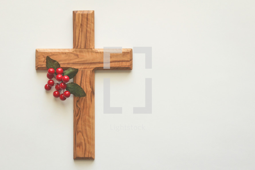 wooden cross with red berries 