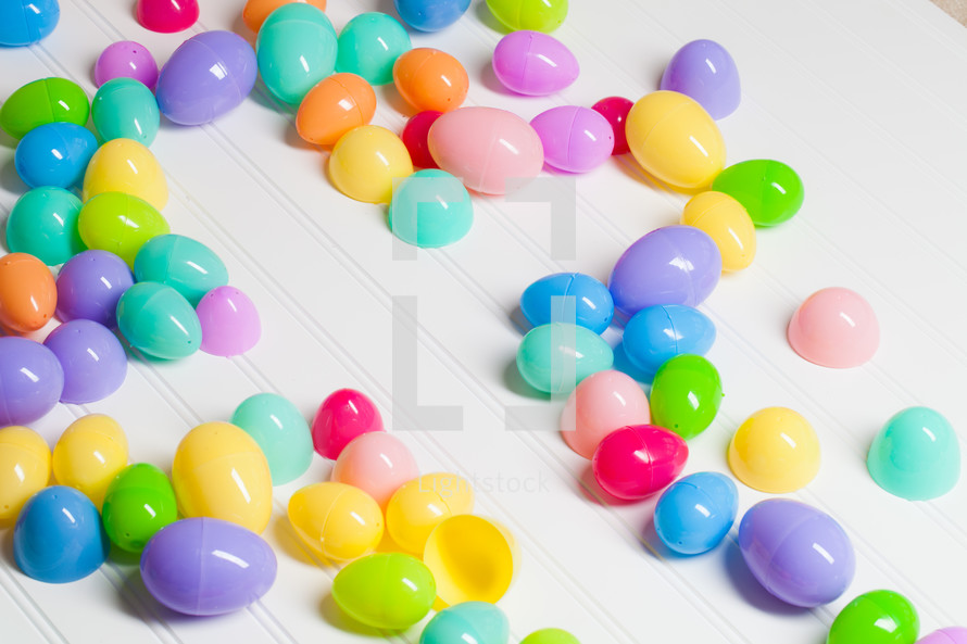 Shape of a cross bordered with plastic Easter eggs.