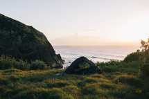 camping in a tent near a shore 