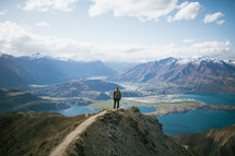 a woman standing on a mountaintop in New Zealand 