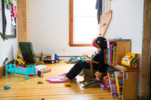 child in a messy playroom