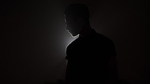 a man standing in a spotlight 
