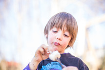 a child eating a roasted marshmallow 